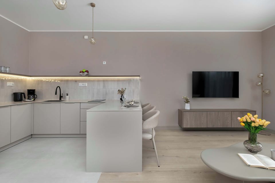 Open-plan living and dining area with a modern TV wall and stylish décor.