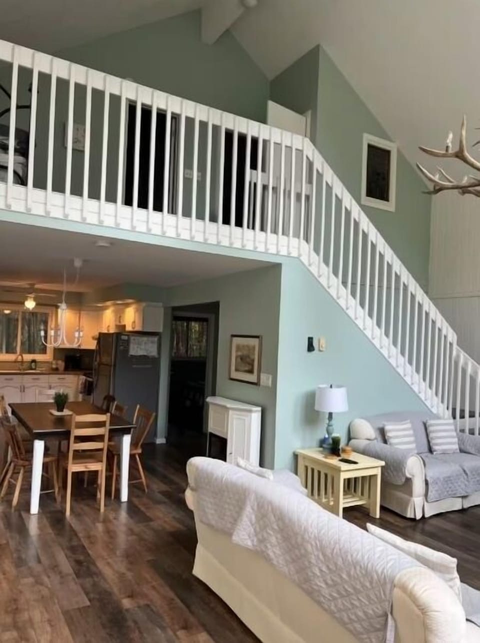 An inviting open-concept space where the kitchen, dining, and living areas flow together seamlessly — perfect for sharing meals, playing games, or simply relaxing by the fire.