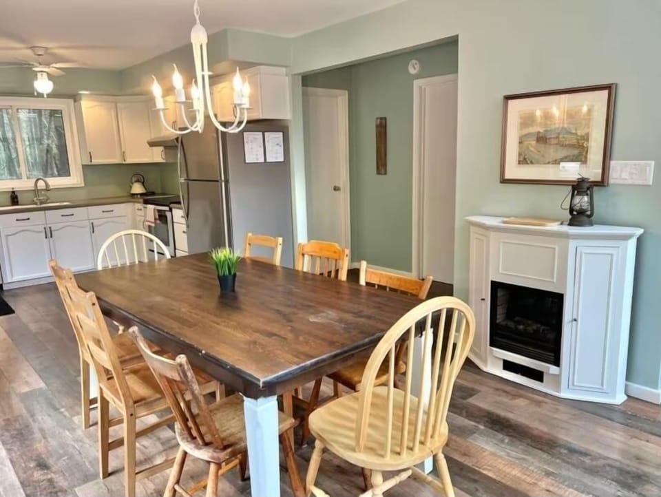 Gather around the spacious dining table for family meals or game nights. The open-concept design lets in natural light and connects seamlessly to the living room and outdoor deck.
