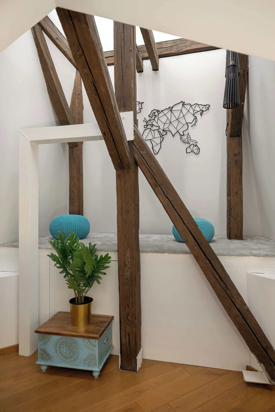 A decorative wall features an artistic outline of continents. The minimalist style adds character to the bedroom.
