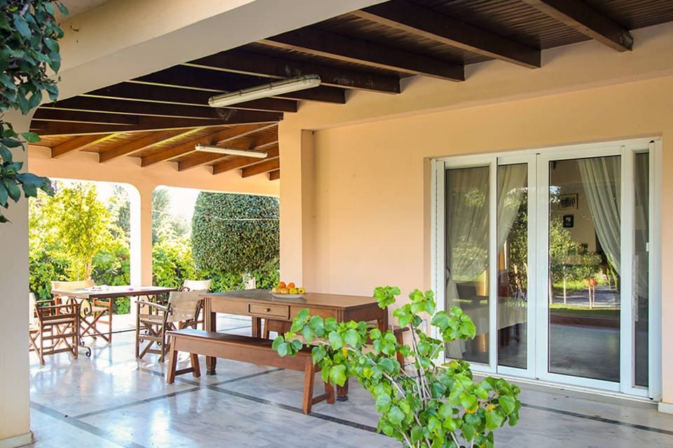 Open veranda with seating and direct access to the garden, offering a peaceful outdoor space to enjoy throughout the day