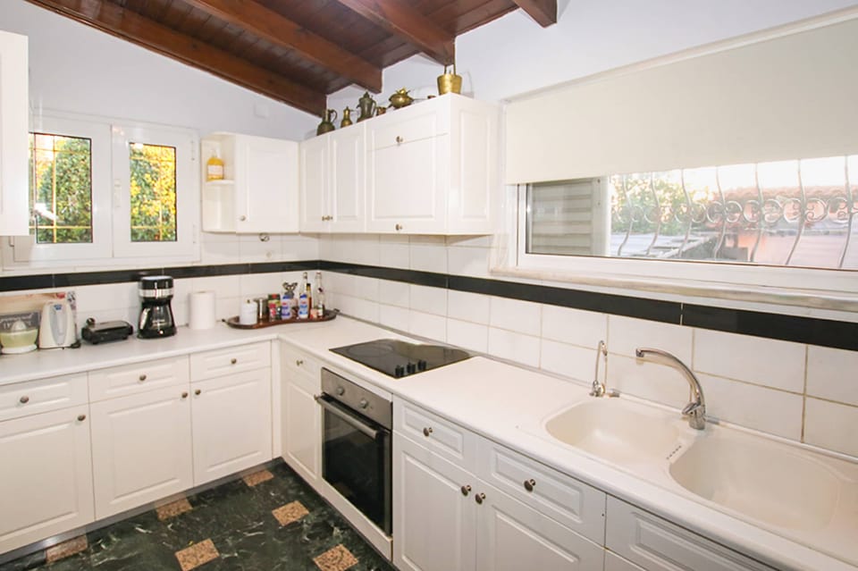 Bright and spacious kitchen with full appliances, extensive counter space, and everything needed for home cooking