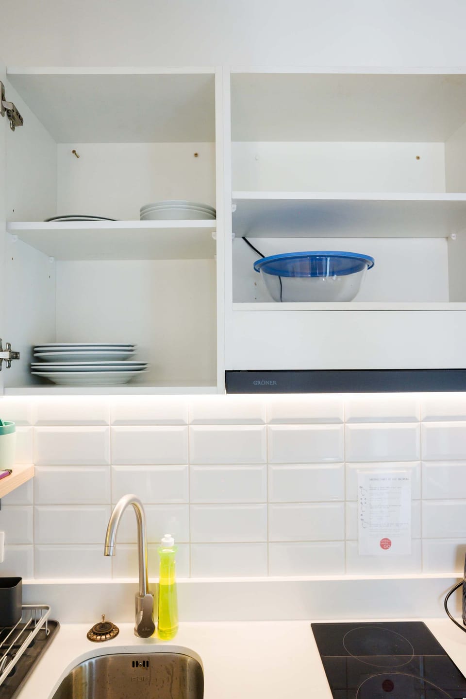 Modern kitchen with sleek design and essential amenities for a comfortable stay.