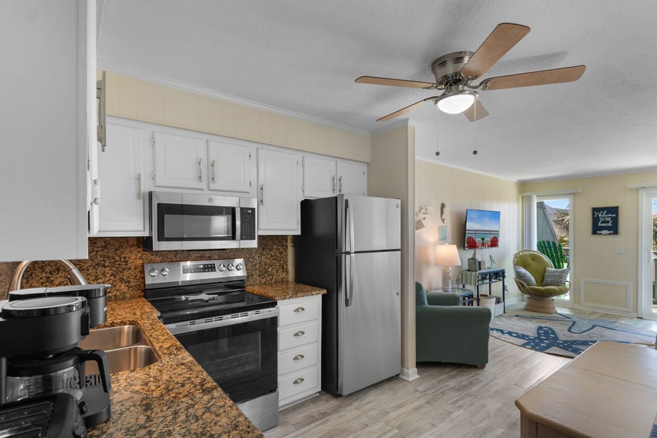 Your fully equipped kitchen flows seamlessly into the bright living area, perfect for cooking memorable meals while staying connected with your group.