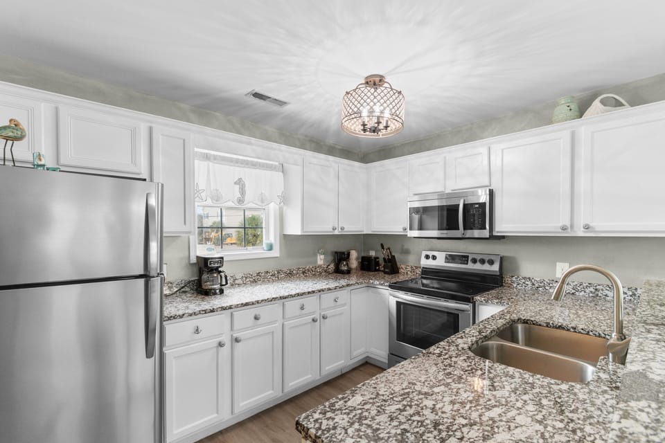 Your fully equipped kitchen features granite countertops, stainless steel appliances, and everything you need to create memorable meals during your stay.