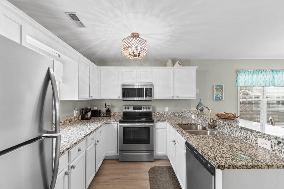 Your fully equipped kitchen features granite countertops, stainless steel appliances, and ample space to create memorable meals during your stay.