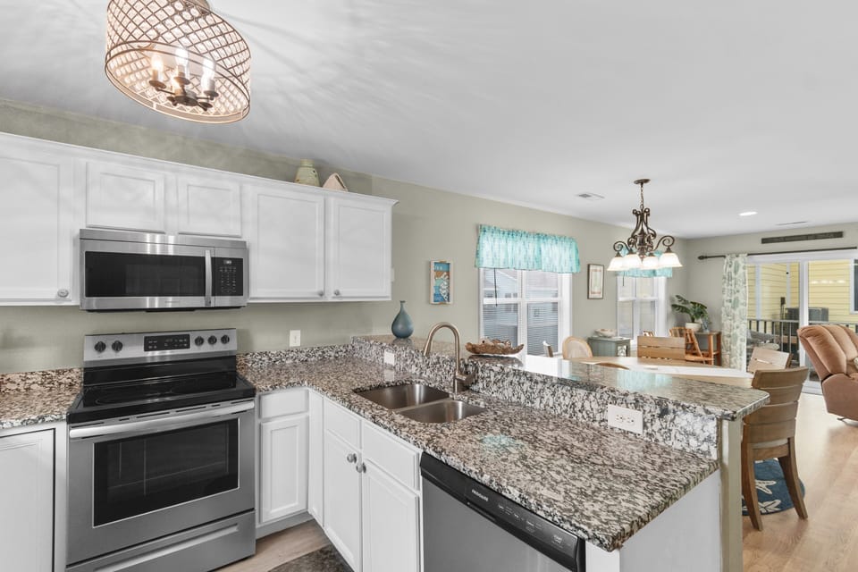 You'll love this spacious kitchen with granite countertops, stainless steel appliances, and open flow to the dining area—perfect for cooking memorable meals.