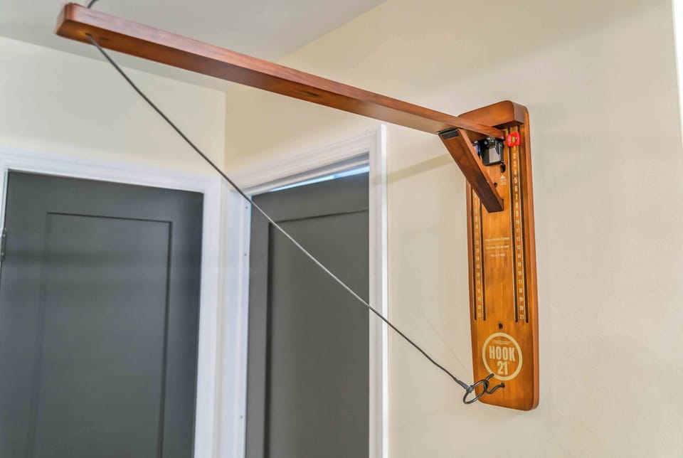 This fun indoor Hook and Ring Toss game adds a playful touch to the hallway—perfect for some friendly competition between guests during downtime.