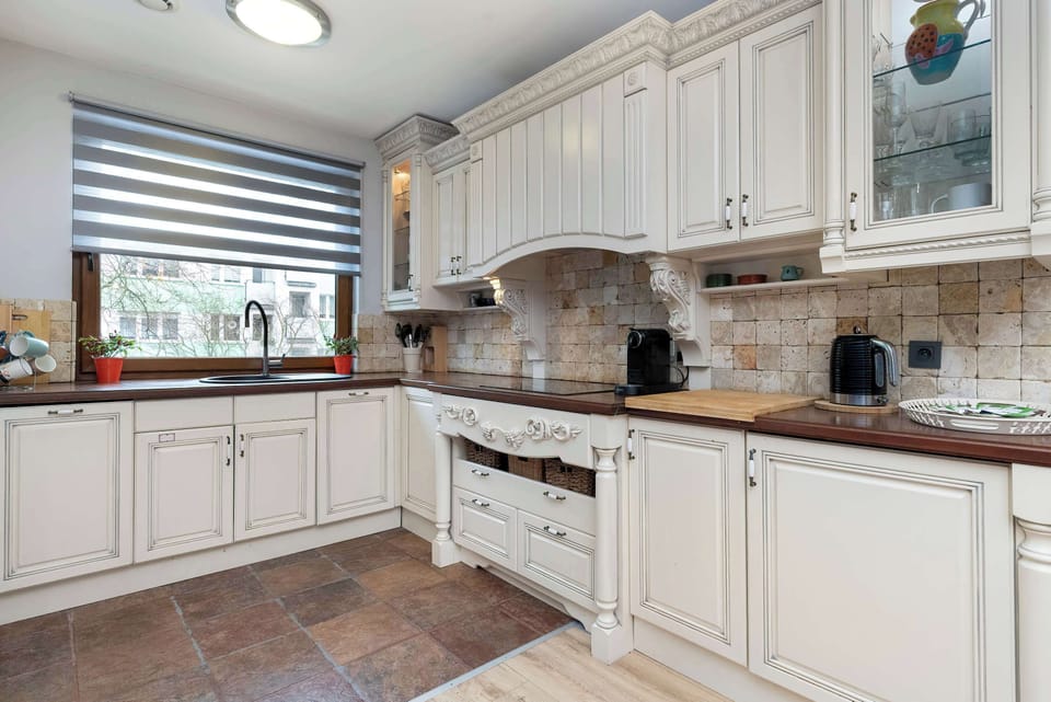 The spacious kitchen with classic cabinetry and generous counter space makes meal preparation comfortable, even for multiple guests at once.