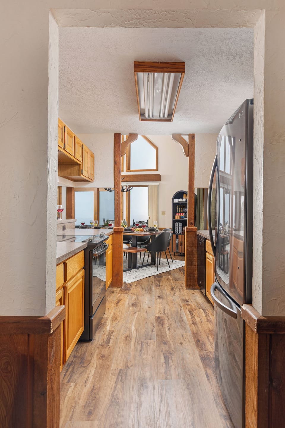 Galley kitchen flows to dining area, fully stocked with cookware and essentials