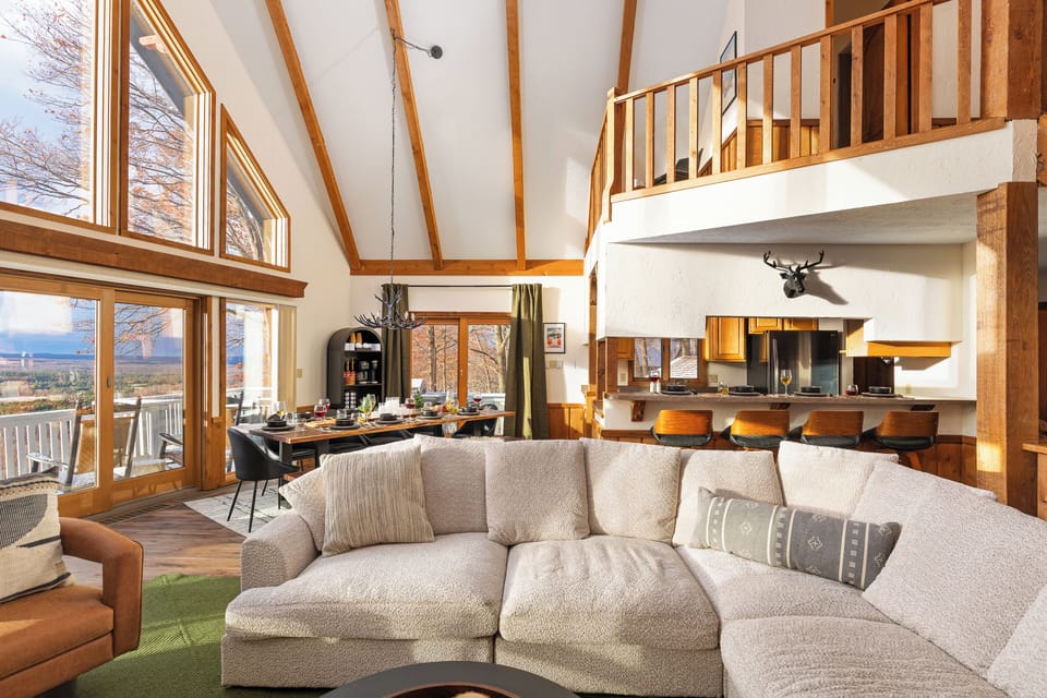 Large cozy sectional with leather chairs creates a warm great room for gathering