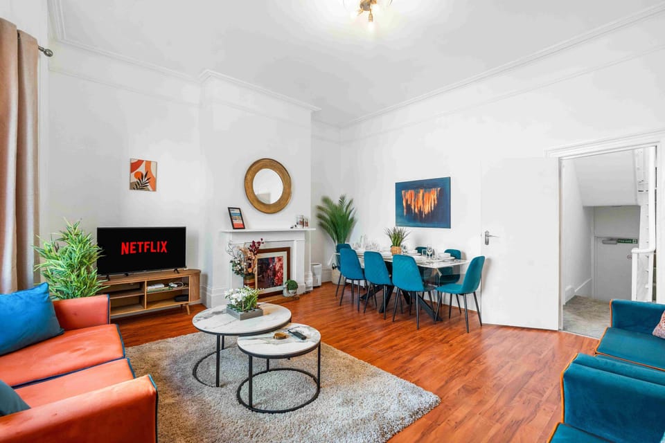 Bright open-plan living and dining area with two sofa beds