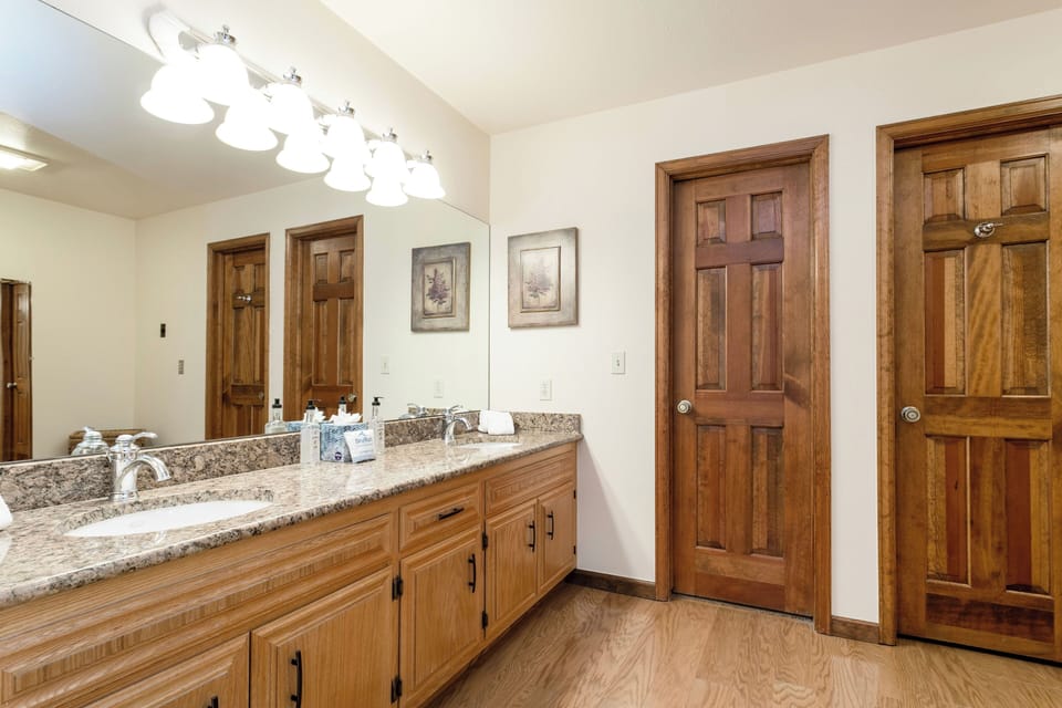 Spacious bathroom with dual vanities and granite countertops offers plenty of room for your morning routine, complete with quality finishes and thoughtful amenities.