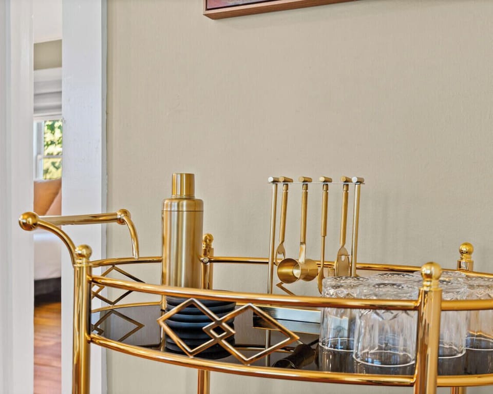 Golden bar cart poised for cocktail o’clock—shaken or stirred?