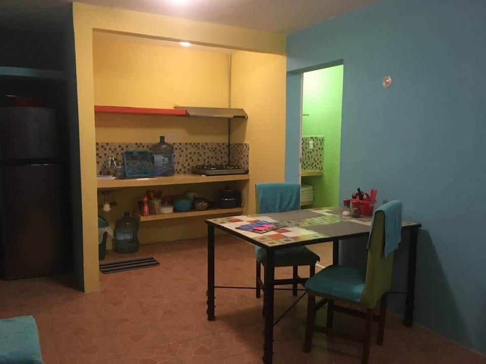 Kitchen and table are in close proximity for cooking and dining.  Standard size fridge and freezer. 