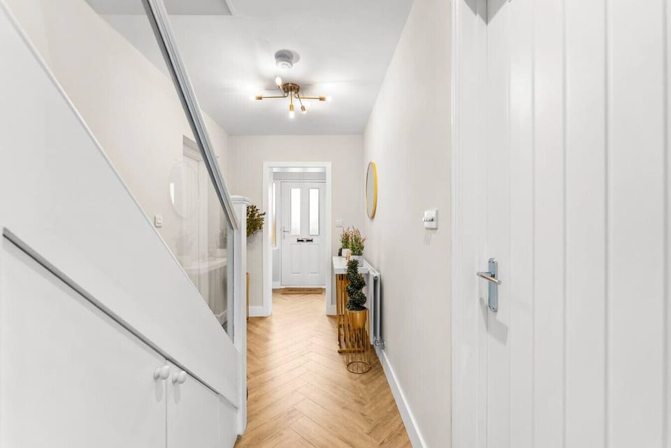 View of the front door from the open plan living, dining and kitchen area