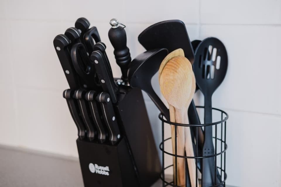 A handy selection of kitchen knives and utensils is provided for your convenience.