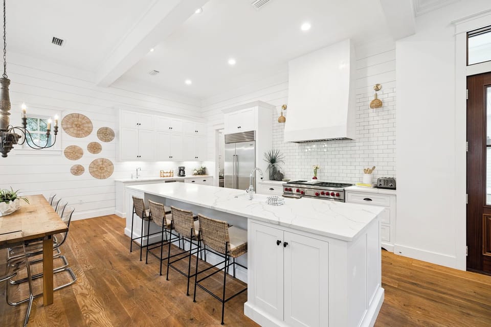 Gather around a bright, spacious kitchen with soaring ceilings, gleaming countertops, and professional-grade appliances perfect for creating memorable meals together.