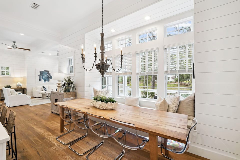 Gather around this welcoming farmhouse table under soaring ceilings and natural light that fills the bright, open-concept living space. Your home away from home invites memorable meals and laughter.