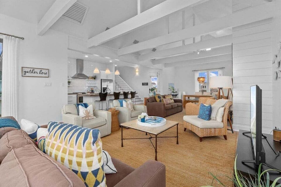 Expansive open floor plan connecting living room and kitchen – modern beach home design