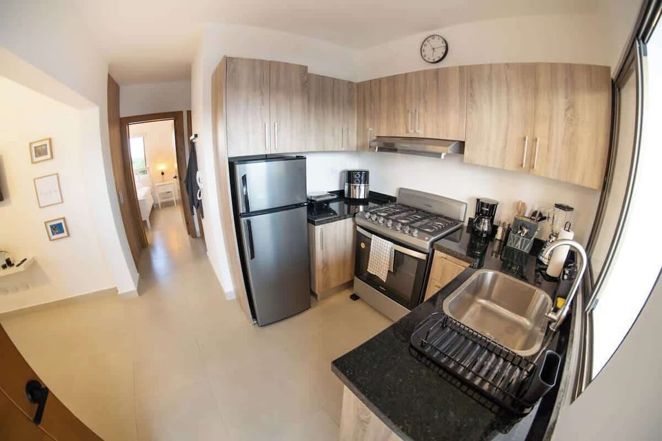 - Open kitchen and hallway view with modern appliances and storage
- Easy access layout for cooking dining and daily living
- Bright clean space ideal for extended stays and self catering needs
