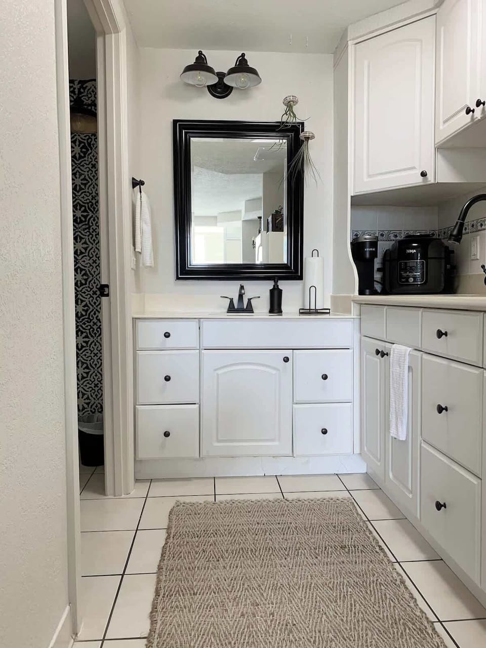 - Clean kitchenette with white cabinets and essential appliances
- Compact design perfect for easy meals and quick snacks
- Includes sink, storage, and functional prep space for stays    
