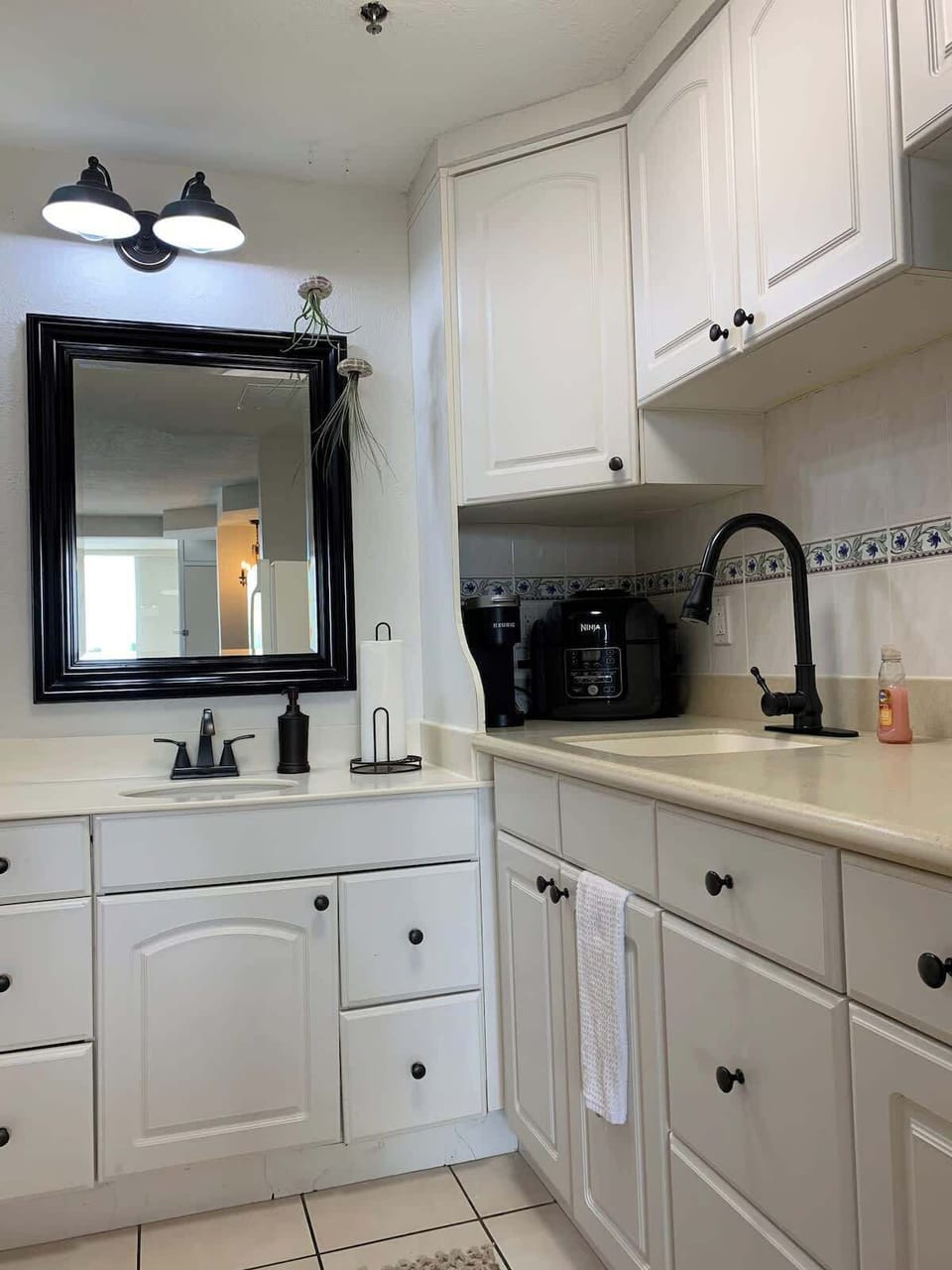 - Clean kitchenette with white cabinets and essential appliances
- Compact design perfect for easy meals and quick snacks
- Includes sink, storage, and functional prep space for stays    
