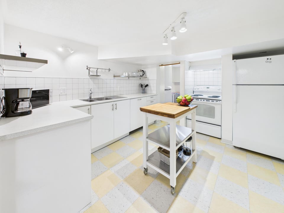 Whip up delicious meals in the full kitchen equipped with a rolling butcher block island.