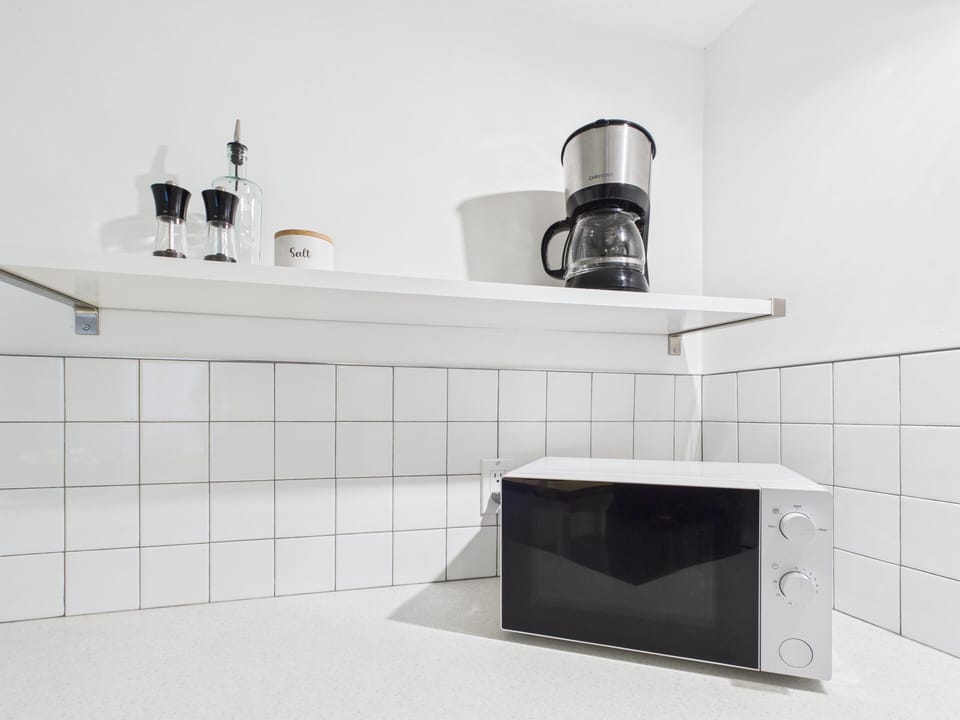 Start your day right at the dedicated coffee station stocked with essential kitchen tools.
