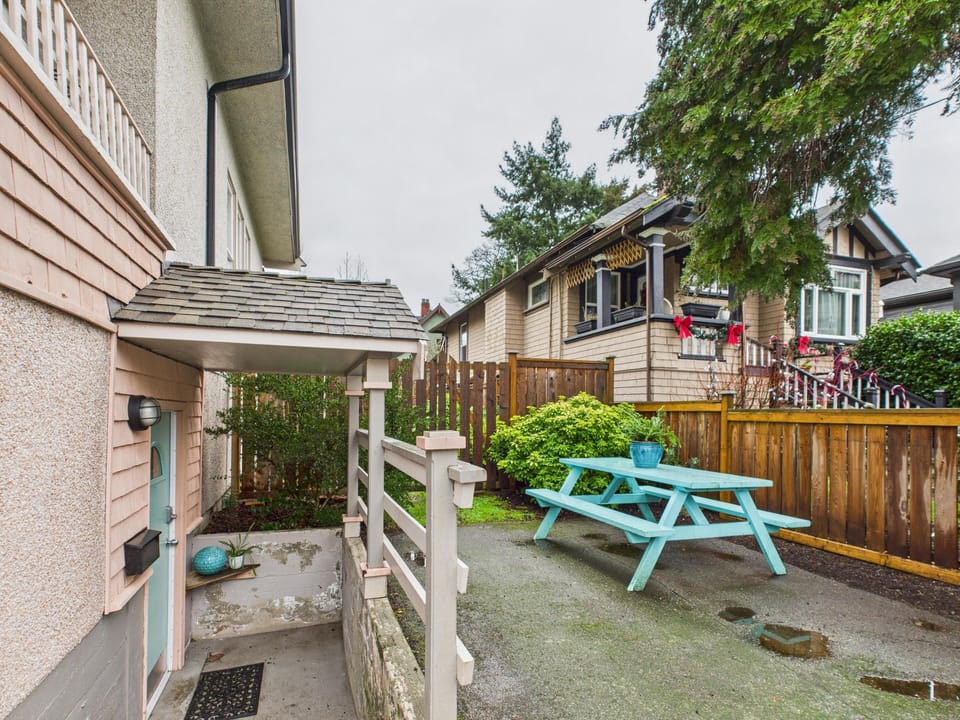 Step outside to your private fenced garden patio featuring outdoor seating and green space.