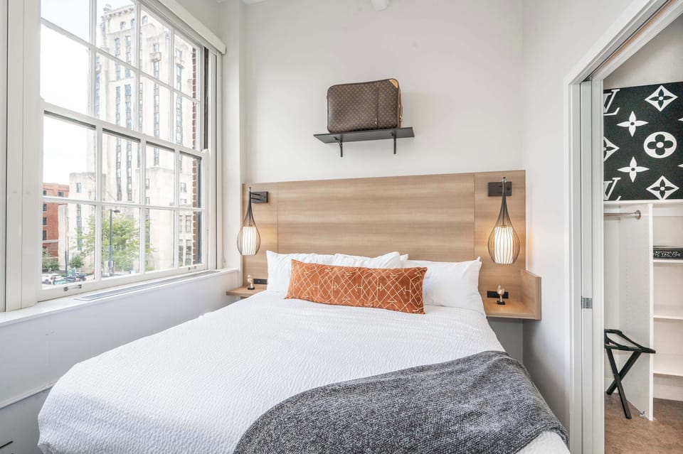 Suite 301’s primary king bedroom offers a smart TV & shared ensuite bath​​