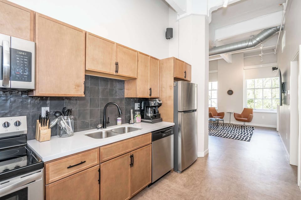 Suite 201’s sleek kitchen offers ample space & all the comforts of home​​