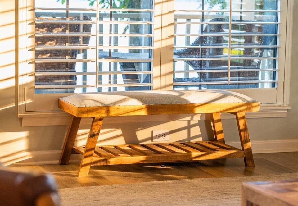 Sunny window nook with a rustic bench—ideal for reading or relaxing.