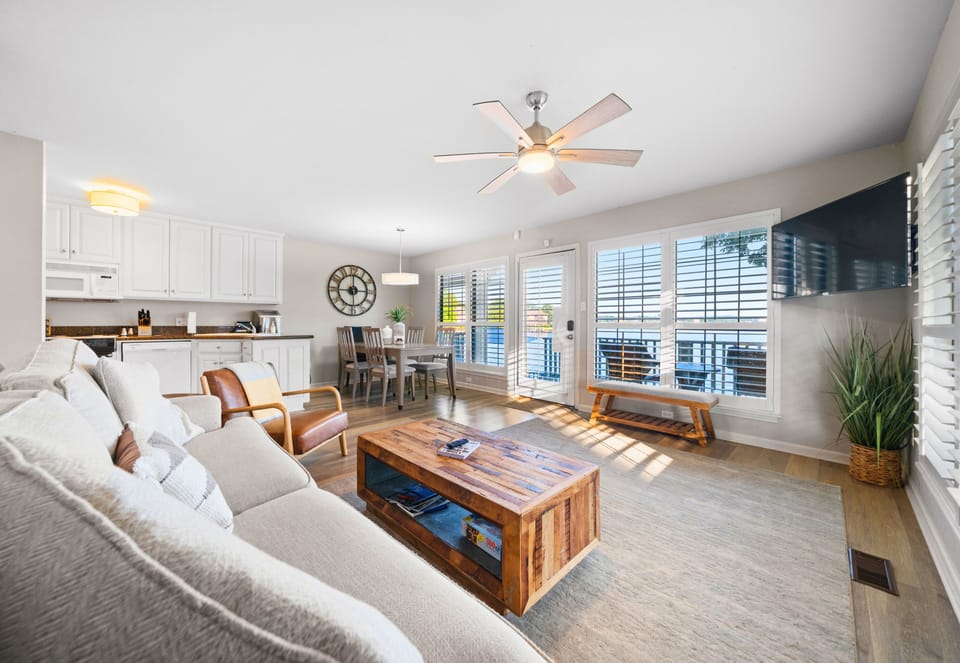 Spacious living room with sectional sofa and lake views.