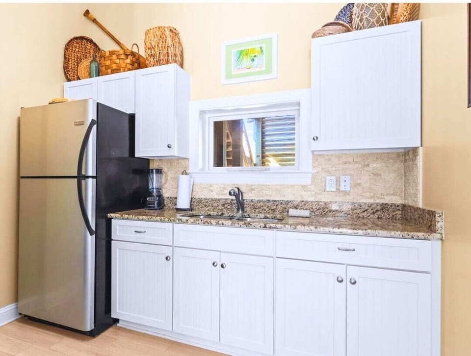 Convenient ground-floor kitchenette perfectly positioned near the pool and backyard — making outdoor days refreshingly easy.