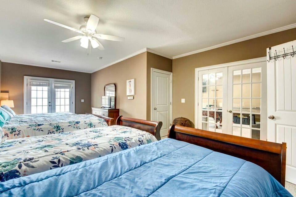 Bedroom 4 | Basement | Queen & Two Full Beds, Ceiling Fan & Private Balcony Access