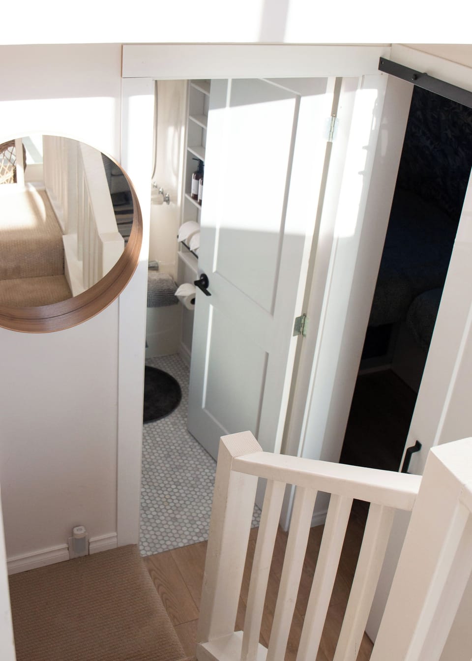 Just at the bottom of the stairs, you'll find the bathroom and second bedroom