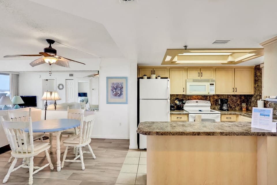 Enjoy an open beach stay layout with a full kitchen, breakfast bar, and cozy dining area. Perfect for gathering, dining, and relaxing after a fun-filled day by the ocean.