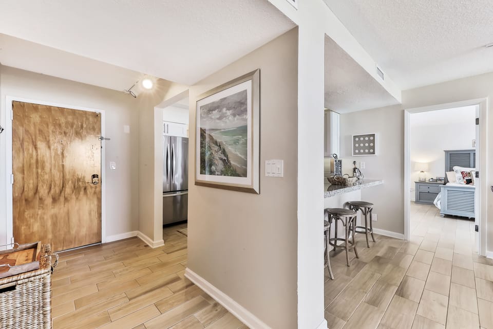 Bright, welcoming entryway with coastal artwork and easy flow to the kitchen and bedrooms. Set the tone for a relaxing and comfortable beach stay from the moment you arrive.
