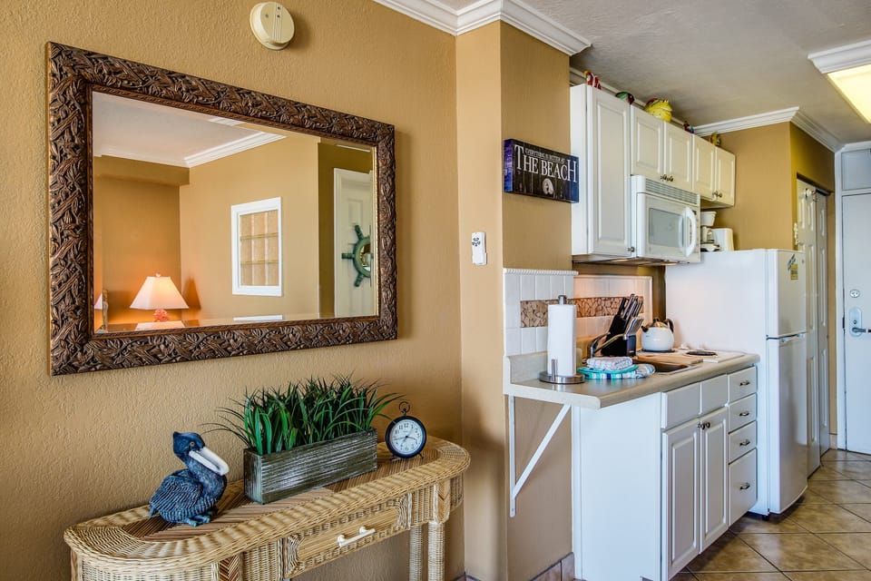 Welcoming beach stay kitchen and entry area with coastal accents and convenient amenities. Designed for comfort and ease, it sets the tone for a relaxing beach vacation just moments from the ocean.