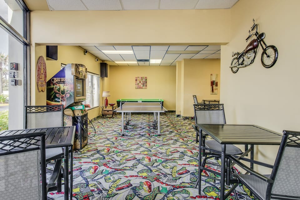 Enjoy downtime during your beach stay in the on-site game room featuring table games and seating. A fun spot to relax, socialize, and unwind between beach adventures and sunny seaside activities.