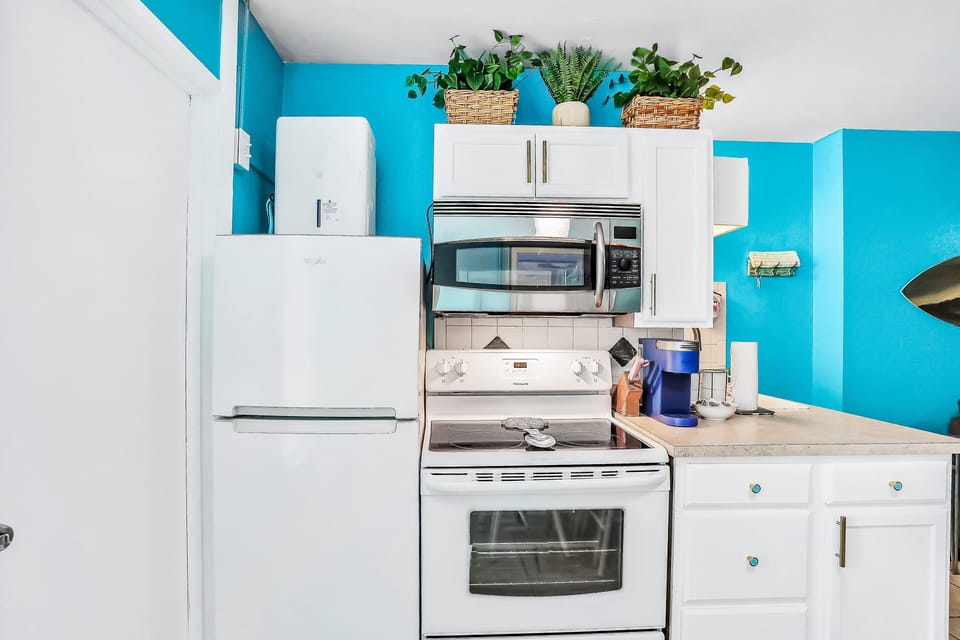 Prepare meals with ease in this bright beach stay kitchen featuring modern appliances, ample counter space, and coastal accents. Ideal for quick breakfasts or relaxed dinners after a day at the beach.
