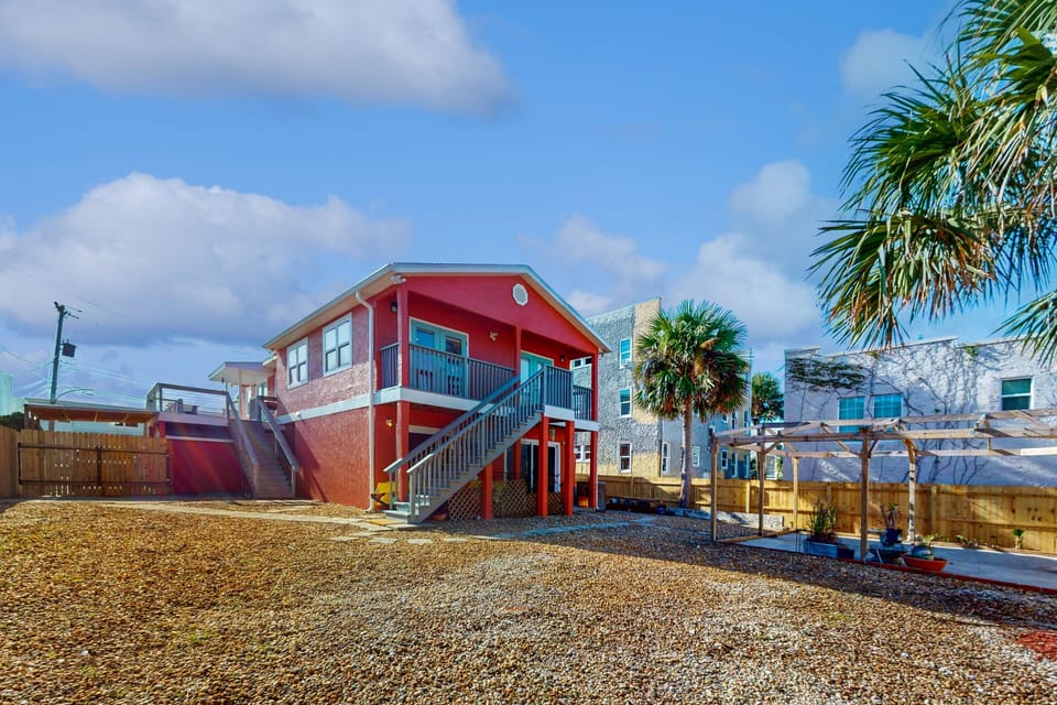 This charming coastal home features a raised design, private yard, and outdoor space perfect for relaxing after a day by the shore. An inviting setting to enjoy fresh air and unwind during your beach stay.
