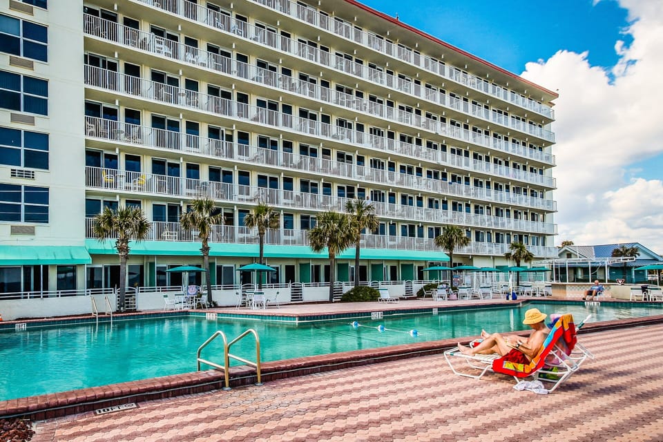 Enjoy your ultimate beach stay at this oceanfront resort featuring a sparkling pool, palm-lined sundeck, and lounge seating. Relax under the sun just steps from the beach, with coastal views and resort-style amenities throughout.