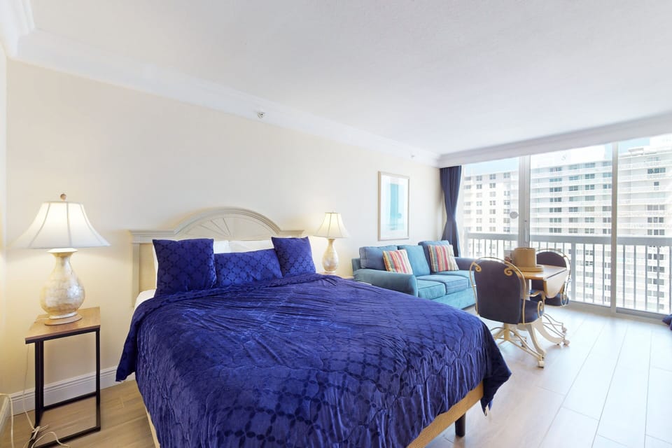 Relax in this spacious oceanview studio featuring a plush king bed, cozy sitting area, and dining space. Enjoy a refreshing beach stay with plenty of natural light and comfort steps from the shoreline.