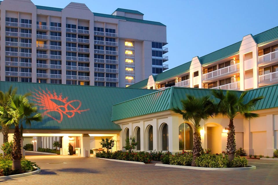 Welcome to your beachfront escape! This inviting resort entrance sets the tone for a relaxing beach stay, offering warm lighting, tropical landscaping, and easy access to oceanfront amenities.