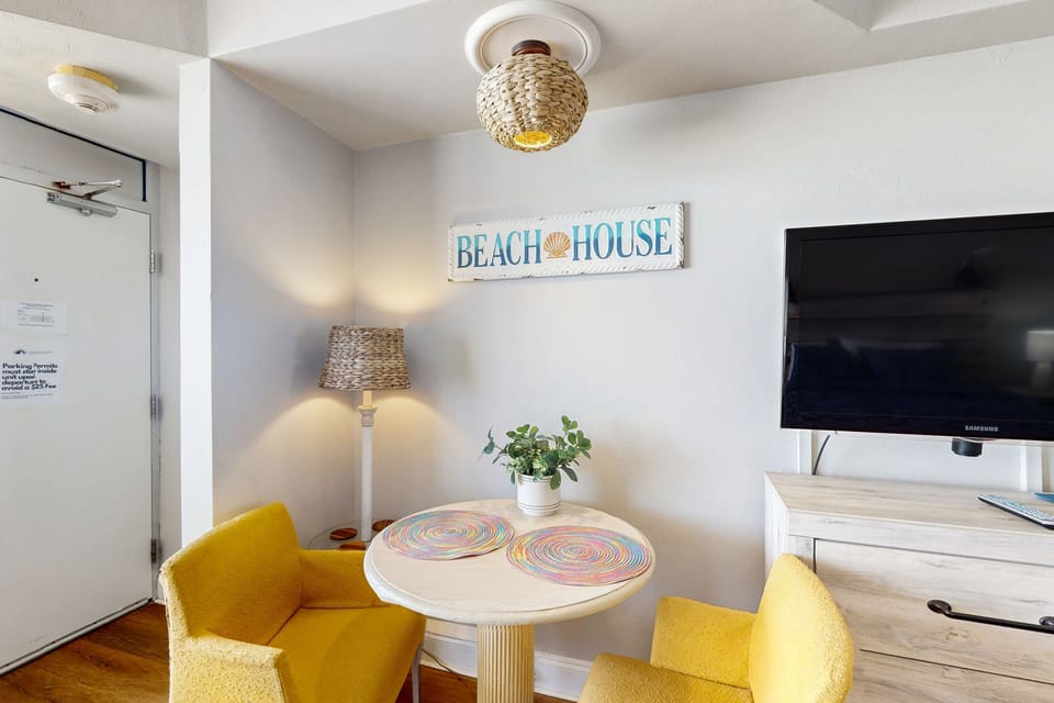 Charming beach stay dining nook with bright seating, coastal décor, and warm lighting. A perfect spot to enjoy morning coffee before heading out for a relaxing day by the ocean.