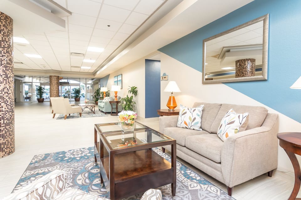 This bright beach stay lobby offers cozy seating, modern décor, and a welcoming atmosphere—perfect for relaxing before heading out to enjoy the shoreline.