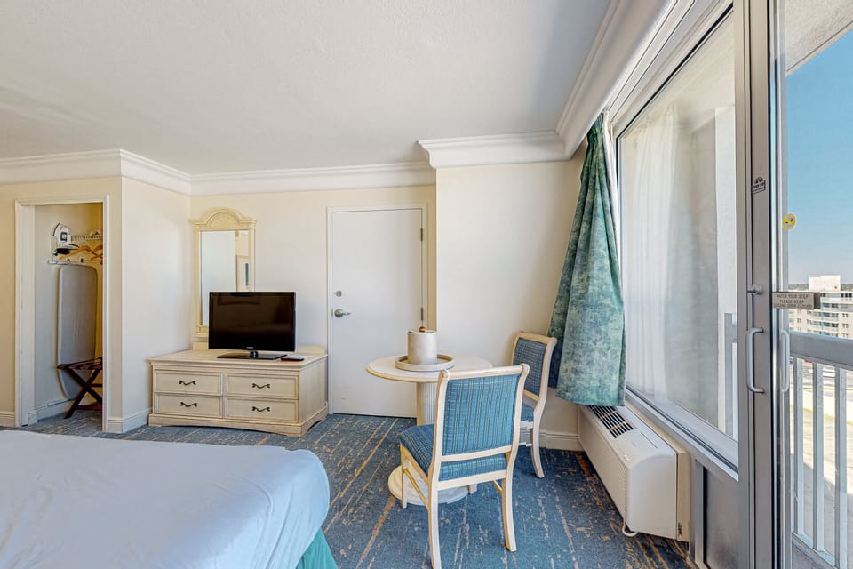 Bright, beach-inspired seating area with direct balcony access. Enjoy ocean breezes, natural light, and a relaxing place to unwind during your coastal stay.