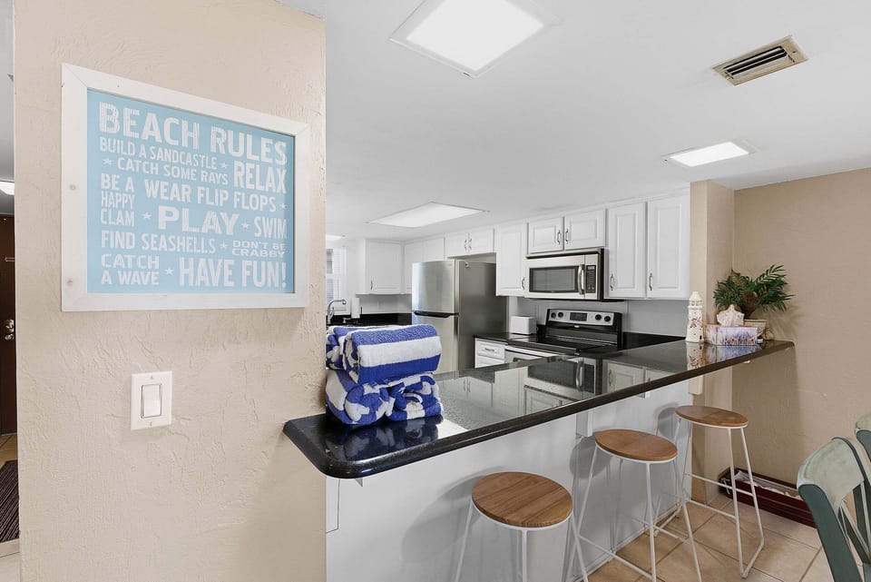 Start your beach stay at this stylish kitchen bar with seating for quick bites and morning coffee. Featuring modern appliances and coastal décor, it's a perfect spot to gather before heading out to the beach.